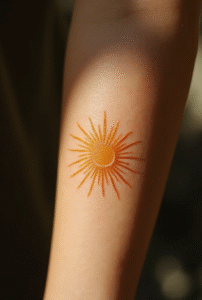 “Minimal sunburst tattoo for women symbolizing new beginnings – elegant small tattoo idea for 2025.”