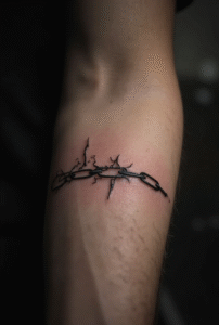 “Small broken chain link tattoo on a man’s inner forearm, drawn with thin separated links representing freedom and breaking limitations.”