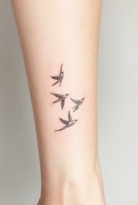 minimal flying bird tattoo design symbolizing freedom, small black line birds in motion for beginners