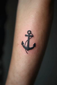 “Tiny anchor tattoo with a small rope gap on a male forearm, designed with thin black lines symbolizing stability and grounding.”