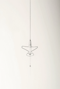 minimal black line airplane tattoo symbolizing travel and freedom, simple and elegant tattoo design for beginners